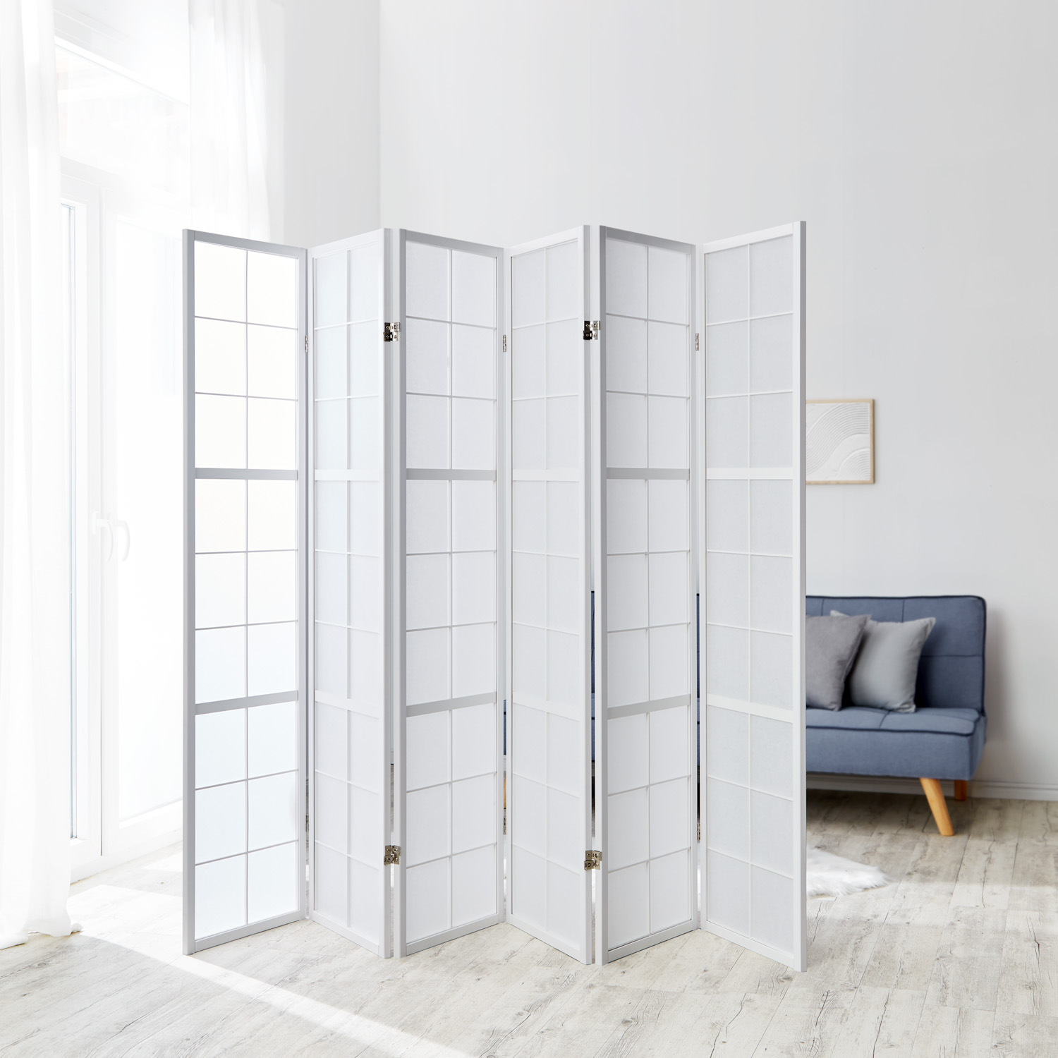 Six?panel white shoji screen with wooden frame, elegant room divider and modern privacy screen in a bright living room.