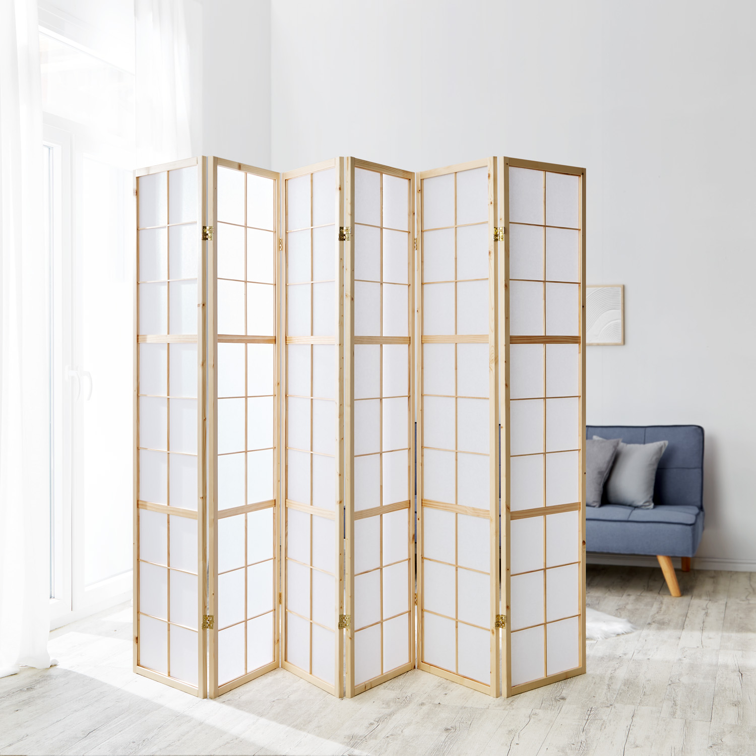 6-panel Shoji room divider with light wooden frame in a modern living room ? Japanese-style screen with translucent paper, perfect for stylish space separation, natural accents, and Asian-inspired interior design.