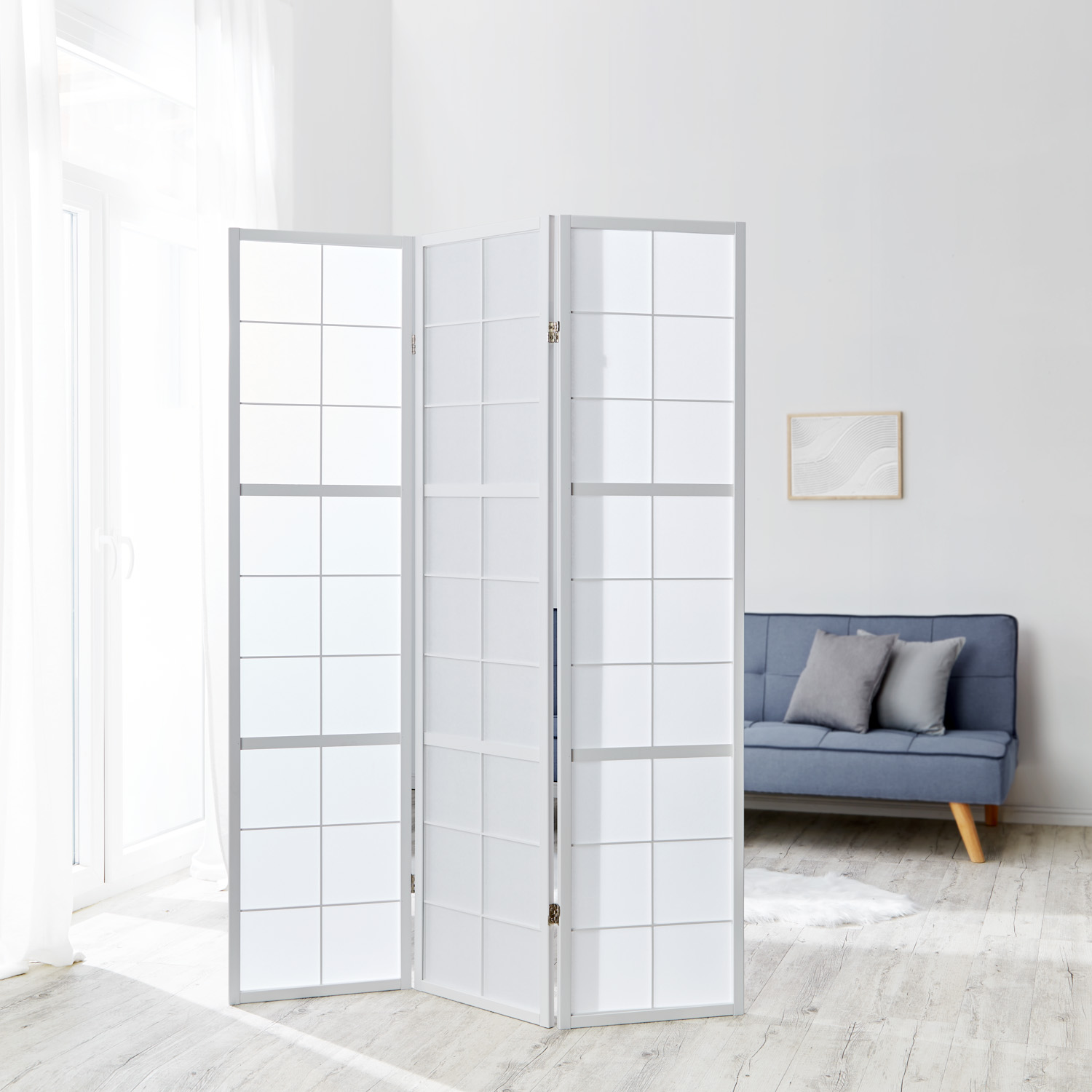 Three?panel white shoji screen with wooden frame in a modern living room, elegant room divider and privacy screen in Japanese style.